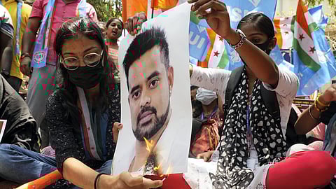 Protestors burn a poster of JD(S) MP Prajwal Revanna during a protest against his involvement in the alleged sexual abuse case.