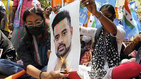Protestors burn a poster of JD(S) MP Prajwal Revanna during a protest against his involvement in the alleged sexual abuse case.