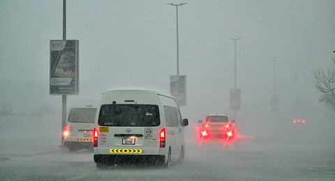 Vehicles drive on a flooded road during torrential rain in the Gulf Emirate of Dubai on April 16, 2024. 