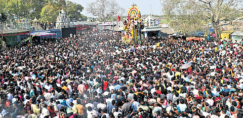 Devotees and transgender devotees gather as Hindu priests take part in a ritual procession pulling the statue of warrior god Aravan on a charriot