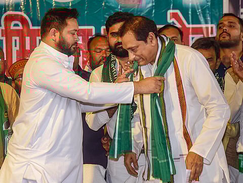 RJD leader Tejashwi Yadav welcomes former Rashtriya Lok Janshakti Party MP Choudhary Mehboob Ali Kaiser as he joins the party, in Patna, Sunday, April 21, 2024. 