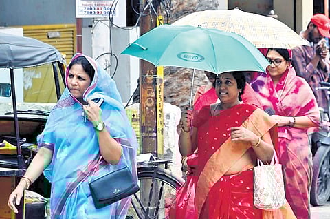 Women cover their heads on a sunny Friday in Karimnagar 