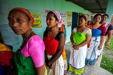 Deori tribal women stand in a queue to cast their vote during the first round of polling of India's national election in Jorhat, Assam.