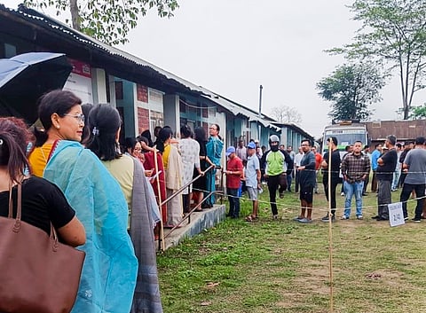 People wait to cast their votes for Lok Sabha elections, in Manipur, Friday, April 19, 2024.