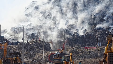 Firefighters attempt to douse the fire that broke out at the Ghazipur landfill site on Sunday, in New Delhi