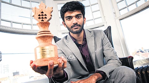 D Gukesh shows his Candidates trophy after emerging victorious at the event in Toronto on Sunday 
