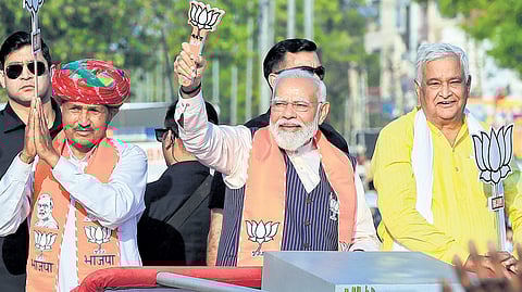 PM Narendra Modi with minister Kirodi Lal Meena at a roadshow in Dausa.
