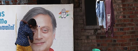 A boy gives his own twist to a poster of Shashi Tharoor who is seeking a fourth term from Thiruvananthapuram Lok Sabha constituency.