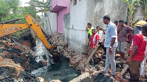 Fire and rescue department officials rescued workers who were stuck in the debris of a collapsed compound wall at Vasanth Nagar, Marapalam, Puducherry on Sunday morning. 