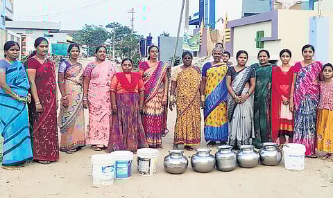 Women from the Narsampet Municipality with their containers as drinking water in the town is supplied only once in four days