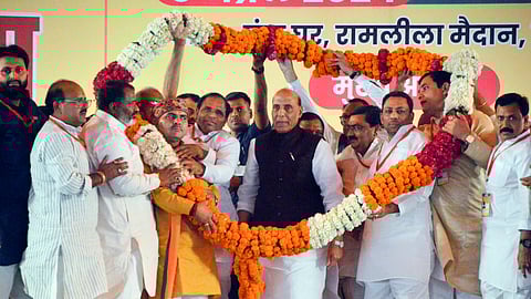 Defence Minister Rajnath Singh being garlanded by BJP workers during a public meeting in support of BJP candidate Atul Garg ahead of upcoming Lok Sabha elections, in Ghaziabad, Wednesday, April 3, 2024.