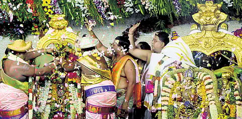 Priest performing celestial wedding of Goddess Meenakshi and Lord Sundareswarar at Meenakshi temple on Sunday in Madurai