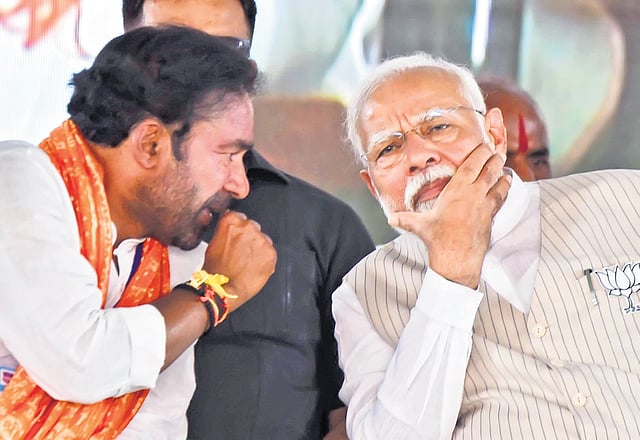 Prime Minister Narendra Modi and state BJP chief G Kishan Reddy during a public meeting in Alladurg mandal under Zaheerabad Lok Sabha constituency on Tuesday 