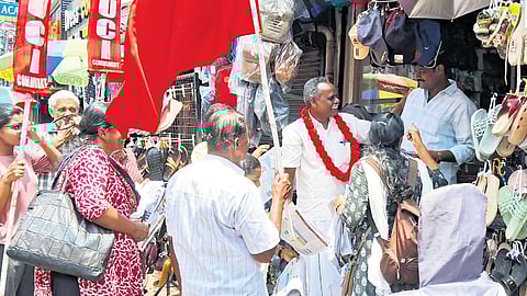 SUCI(C) candidate in Kottayam, V P Kochumon, visits shops as part of election campaigning.