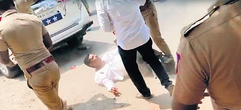 Police allegedly manhandled a DMK functionary as the latter allegedly blocked the road after police forced DMK cadres to remove shelter which was set up to distribute booth slips to the voters