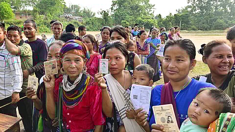 Bru (ethnic group) people show their ID cards as they wait to cast their votes for the second phase of Lok Sabha elections, at a special polling center set up about 170 Km away from Agartala, Friday, April 26, 2024.