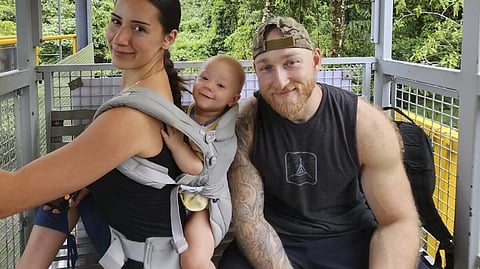 This undated photo provided by John Flickinger, Friday, April 5, 2024, shows Sandy Leclerc, left, and Jacob Flickinger with their son Jasper. 