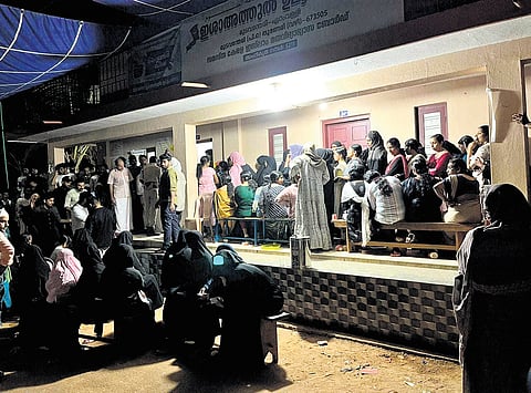 Voters waiting late at night outside polling booth no.19, Isha-athul Uloom Madrassa, at Thuneri in Nadapuram to cast their votes. 
