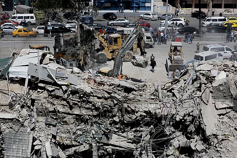 Rescue workers search in the rubble of a building annexed to the Iranian embassy a day after an air strike in Damascus on April 2, 2024.