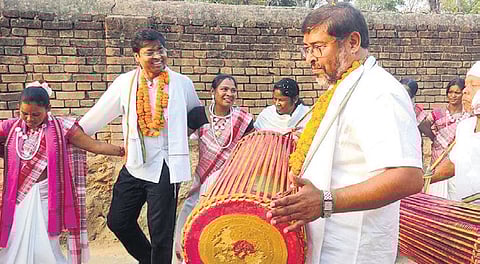 BJD’s Sundargarh LS candidate Dilip Tirkey dancing with tribal women as MLA nominee Jogesh Singh beats the drum at Bhalubahal village