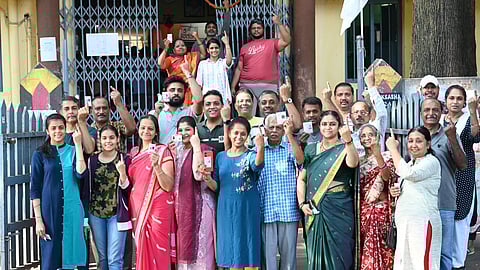 People posed for a photo after casting their votes outside a polling station in Basavanagudi, Bengaluru, on Friday, April 26, 2024.