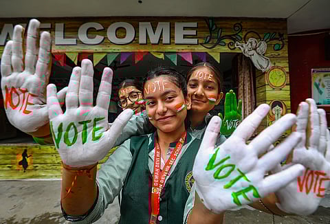 Bharatiya Janata Party (BJP) supporters wear masks of Indian Prime Minister Narendra Modi during an election rally. 