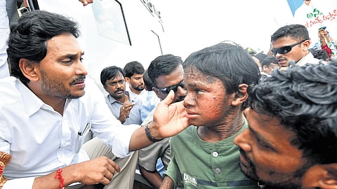 CM Jagan interacting with a child at Dhullipalla in Guntur district on Friday 