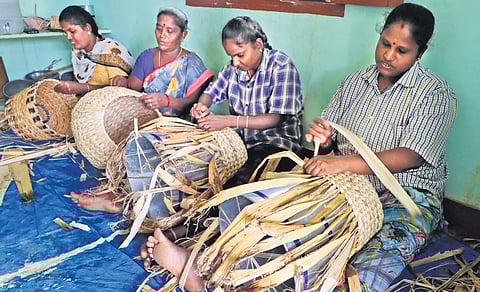 Women involved in weaving baskets using banana fibre in Madurai