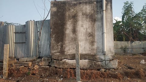 A wall of a house that was damaged as earthmovers were used to level the government land by the landowner