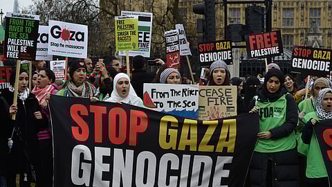 Pro-Palestinian protesters hold banners and placards ahead of a march in support of the Palestinian people in Gaza.