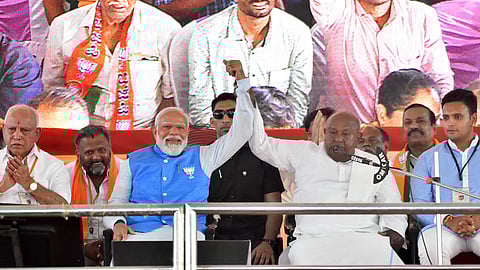 JD(S) supremo H D Devegowda address the gathering during the Lok Sabha poll campaign meeting at Maharaja College grounds.