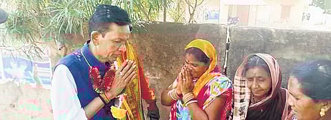 Pradipta Naik talks to voters during campaigning 