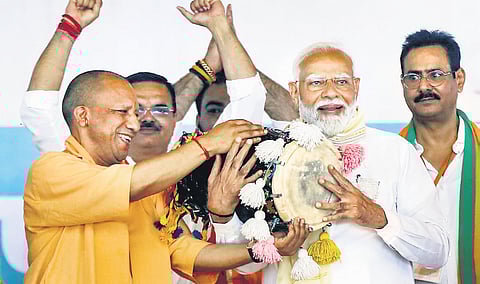 Prime Minister Narendra Modi being felicitated by Uttar Pradesh Chief Minister Yogi Adityanath at Gajraula in Amroha on Friday.