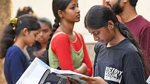 Students and parents from various state waiting outside for CET exams in Bengaluru.