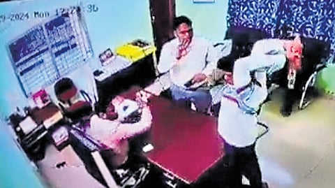 An armed miscreant raises a sharp weapon to attack an official in the deputy director’s office at Nandankanan zoo in Bhubaneswar on Monday  