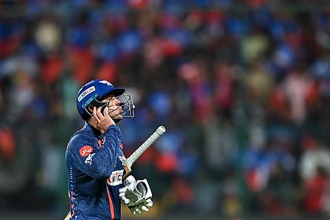 Lucknow Super Giants' Quinton de Kock gestures as he walks back to the pavilion after his dismissal during the Indian Premier League (IPL) Twenty20 cricket match between Royal Challengers Bengaluru and Lucknow Super Giants at the M Chinnaswamy Stadium in Bengaluru on April 2, 2024. 
