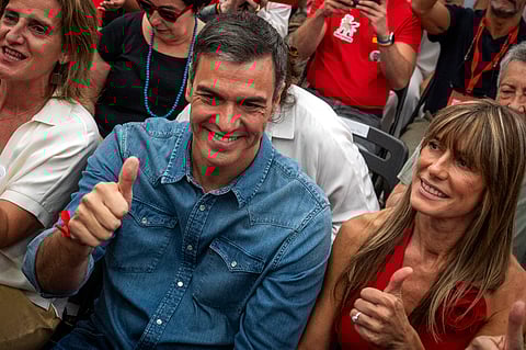 Spain's Prime Minister Pedro Sanchez next to his wife Begona Gomez, gives a thumb up during a campaign closing meeting in Madrid, Spain, Friday, July 21, 2023. 