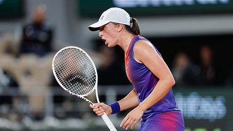 Poland's Iga Swiatek reacts after scoring against Japan's Naomi Osaka during their second round match of the French Open tennis tournament at the Roland Garros stadium in Paris, Wednesday, May 29, 2024.