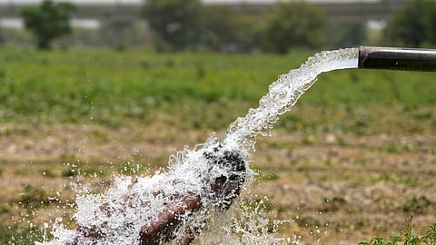 A young man bathes under a tube well on a hot summer day amid the heatwave.