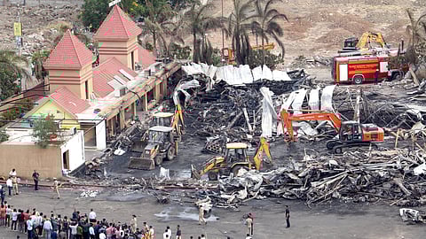 Debris being removed from the game zone site where a major fire on Saturday evening killed at least 28 people in Rajkot.