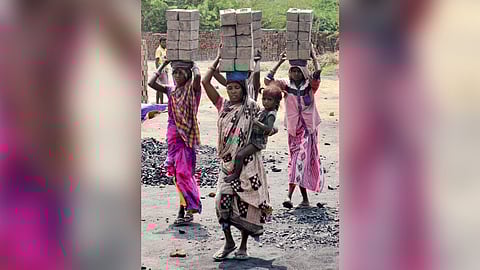 Women are seen working on a brick line in the scorching heat in  Karimnagar on Tuesday