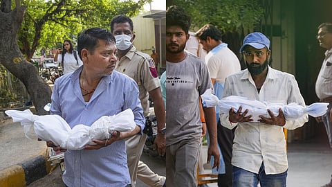 Family members receive their newborn infant's body at GTB Hospital, in New Delhi, Monday, May 27, 2024.