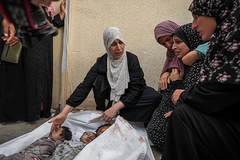 Palestinians mourn their relatives killed in the Israeli bombardments of the Gaza Strip in front of the morgue of the Al Aqsa Hospital in Deir al Balah, Gaza Strip, on Saturday, May 11, 2024.