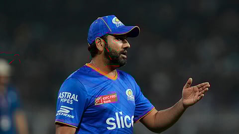 Mumbai Indians' Rohit Sharma gestures as he stands in the field before the start of the Indian Premier League cricket match between Kolkata Knight Riders and Mumbai Indians in Kolkata, India, Saturday, May. 11, 2023.