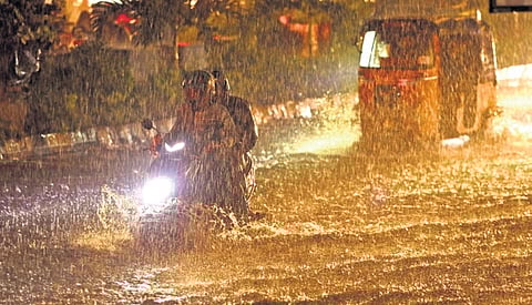 A two-wheeler rider struggles through a flooded road in Hyderabad on Tuesday 
