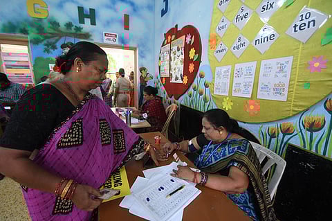 A woman cast get her finger inked at a Sakhi Booth near Salia Sahi in Bhubaneswar.