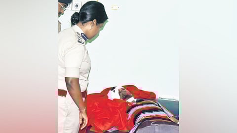 A senior police officer checks on an injured Girish Sawant in Davanagere on Friday