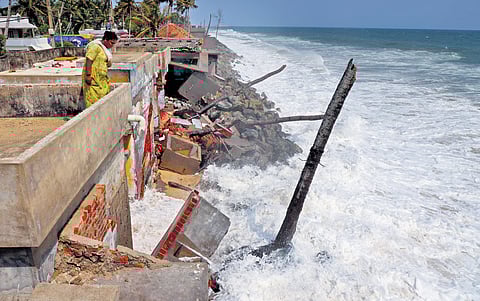 Shiji surveys the damage caused by surging waves to her house in Poothura, Thiruvananthapuram, on Sunday. 
