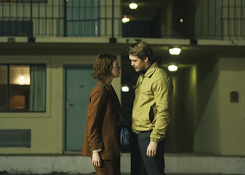 This image released by Searchlight Pictures shows Emma Stone, left, and Joe Alwyn in a scene from "Kinds of Kindness." The film is set to world premiere at the 77th Cannes Film Festival.