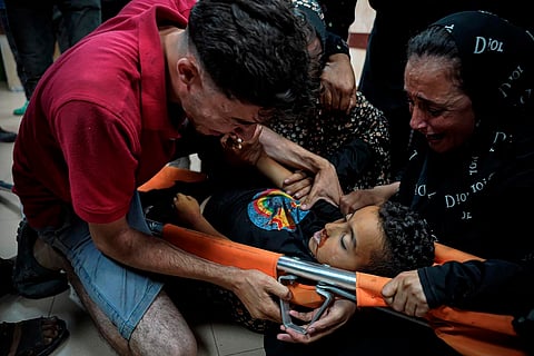 Palestinians mourn their child relative killed in the Israeli bombardment of the Gaza Strip, at Al Aqsa Hospital in Deir al Balah, Gaza Strip, early Sunday, May 12, 2024.